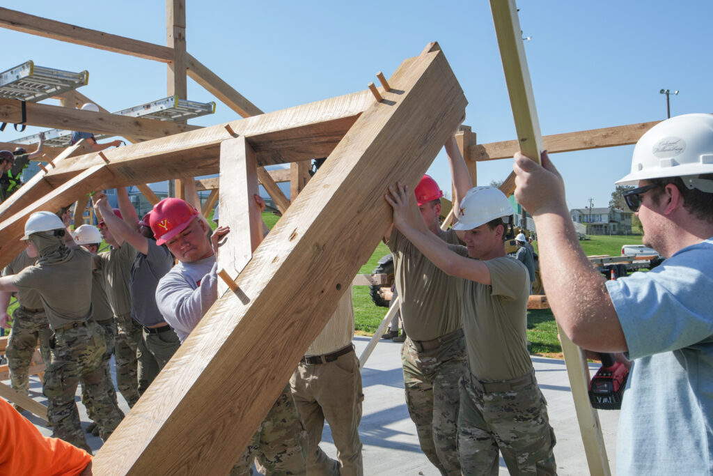 Non-commissioning cadets assist the Timber Framers in erecting a pavilion at Brewbaker Field Sports Complex in Lexington during spring FTX.
