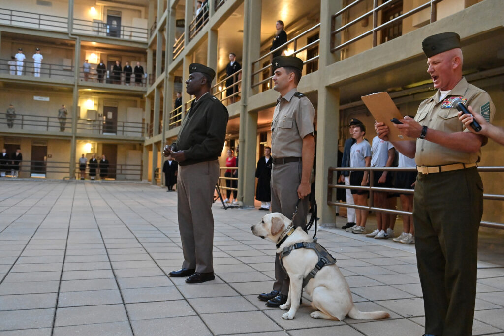 The Corps of Cadets, Maj. Gen. Cedric T. Wins ’85, Col. John P. Casper ’04, and CAVU listen while Sgt. Maj. Tom Sowers reads the orders in New Barracks. –VMI Photo by Kelly Nye.