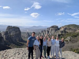 Cadets pose with rock formations and clear blue skies in the background.