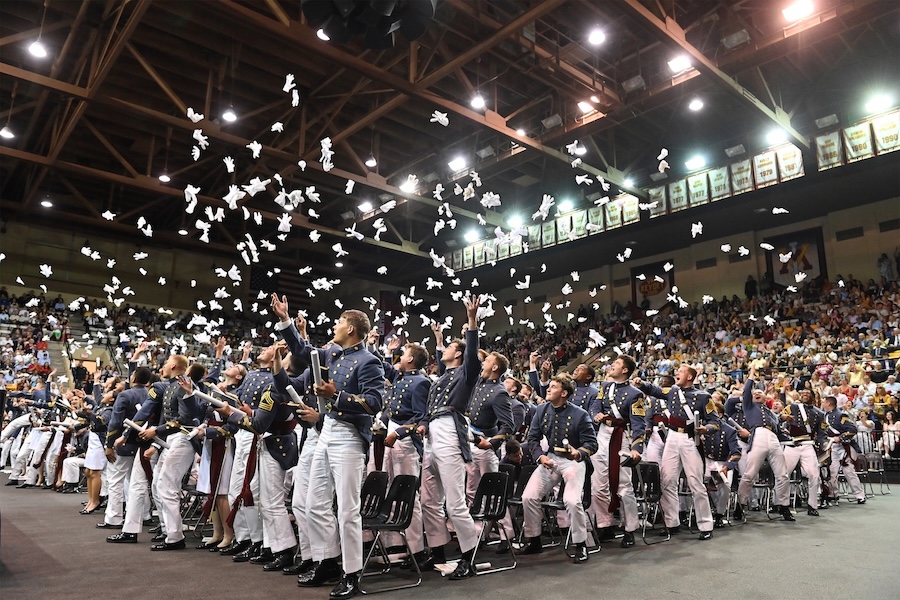 Cadets toss gloves into the air.