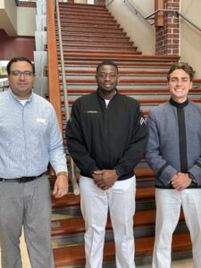 Cadets pose for photo with faculty member.