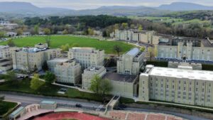 An aerial view of VMI post from Route 11, positioned just over the football field.
