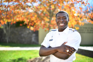 Maximus Ankrah smiles with his arms crossed and his VMI ring on full display.