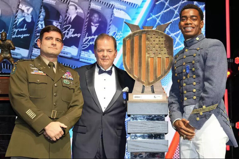 Crump smiles with award and guests of honor.