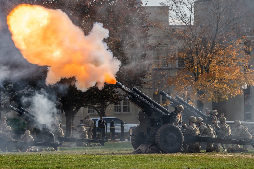 Fire and smoke explode from a howitzer as it is fired in celebration.