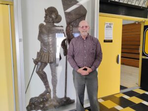 Col. Dan Barr ’74 stands beside the statue of conquistador, Juan Rodriguez Cabrillo.