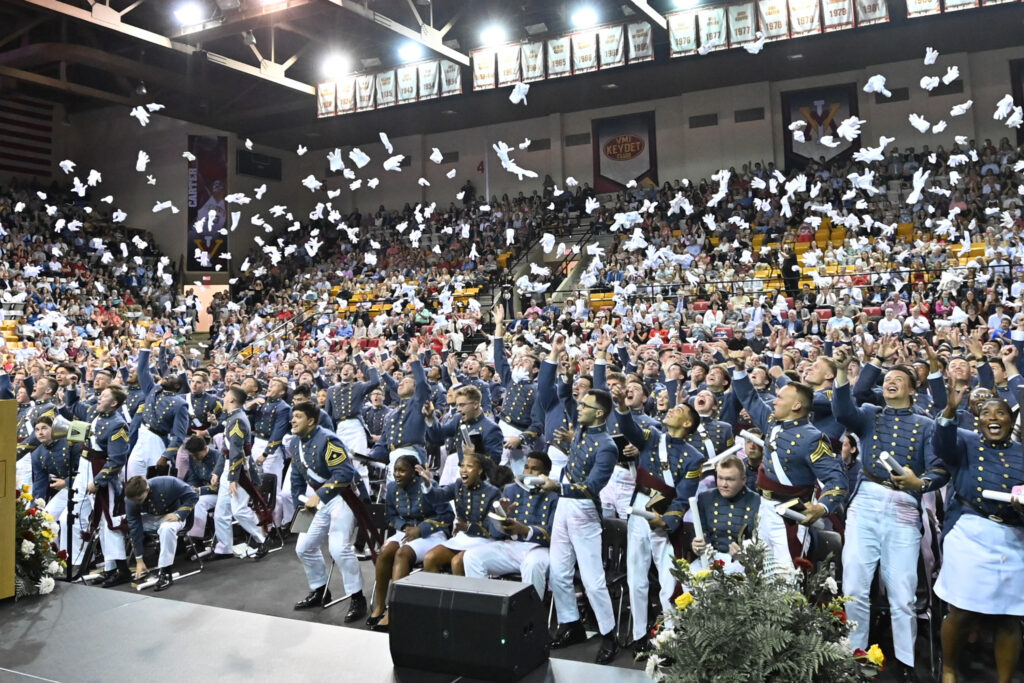 Graduating cadets toss their glove here in celebration.