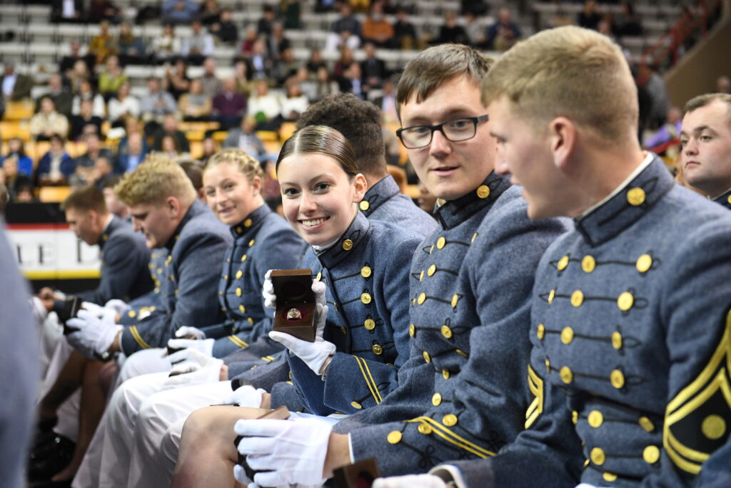 A cadet holds up her VMI ring.