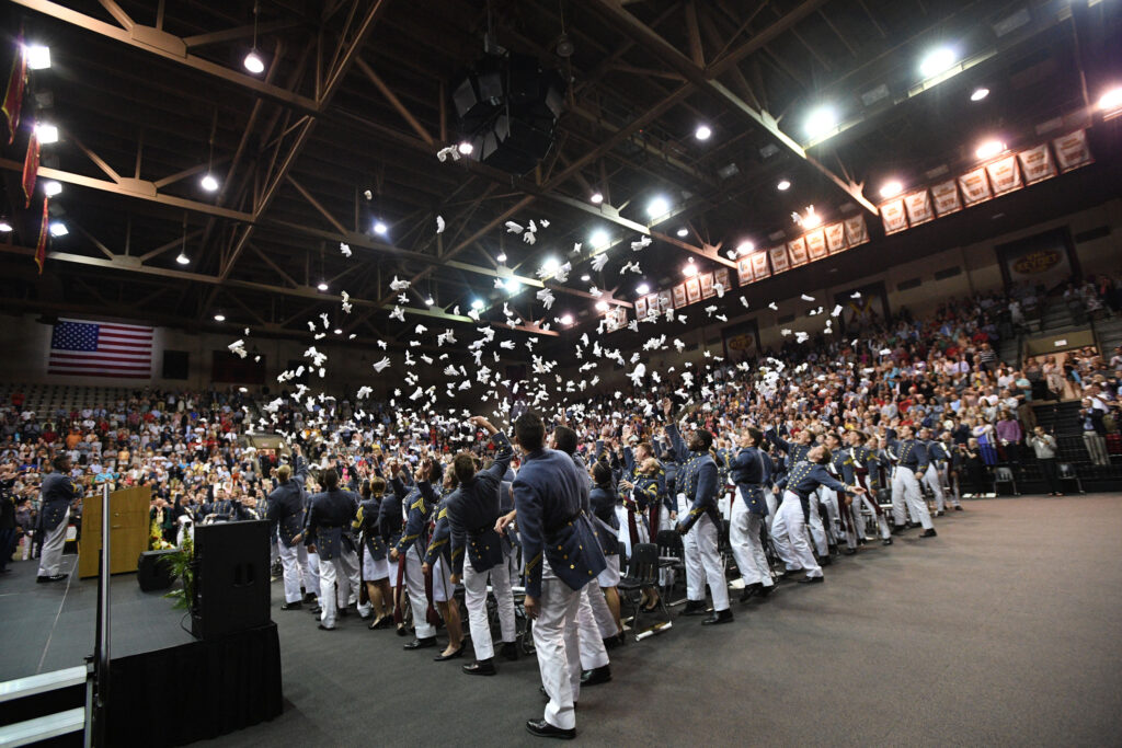Graduates toss their gloves in the air during the 2023 Commencement ceremony.