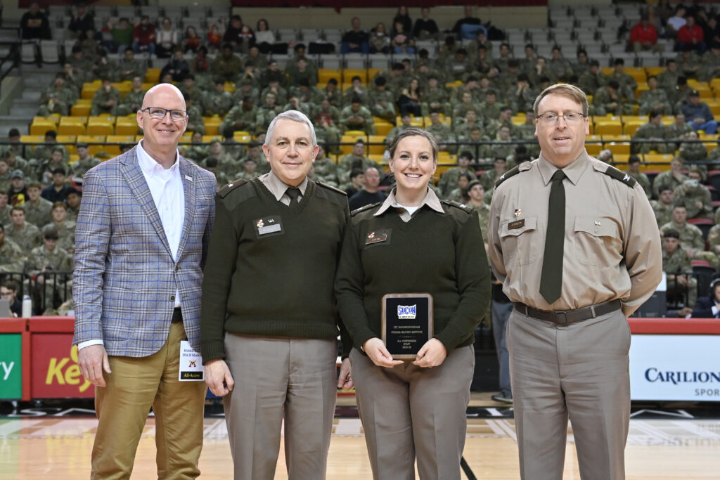 Col. Shannon Eskham stands with her award next to Col. Bob Moreschi, Col. Jay Johnson, and the SoCon president.