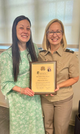 Dr. Sabrina Laroussi congratulates Col. Kathleen Bulger-Barnett