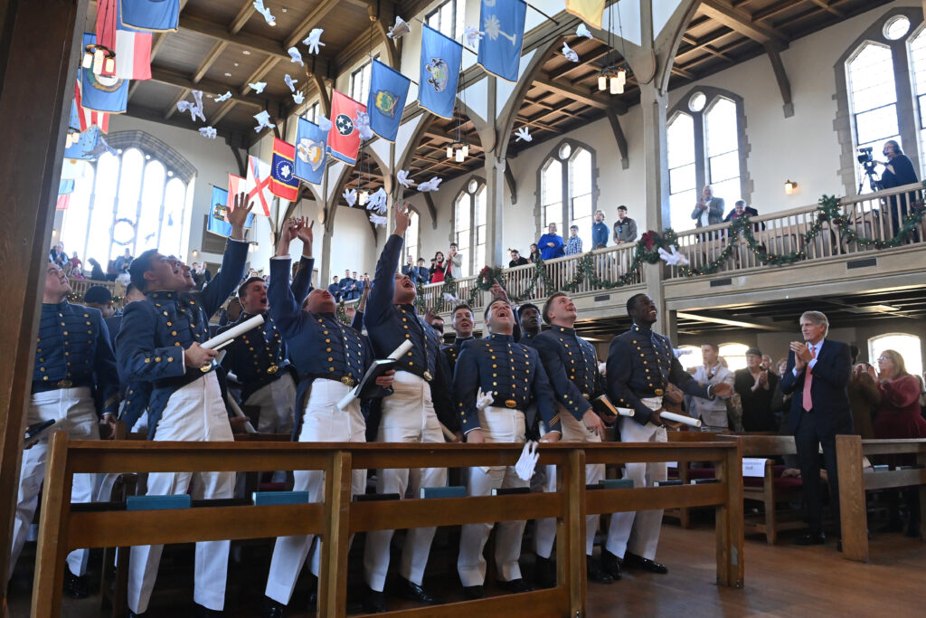 Cadets throw their gloves in celebration.