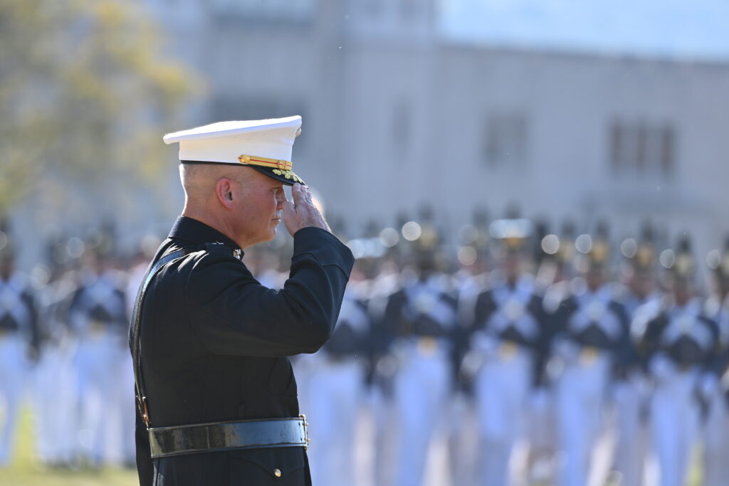 Lt. Gen. David Furness '87 salutes cadets as they march during parade.