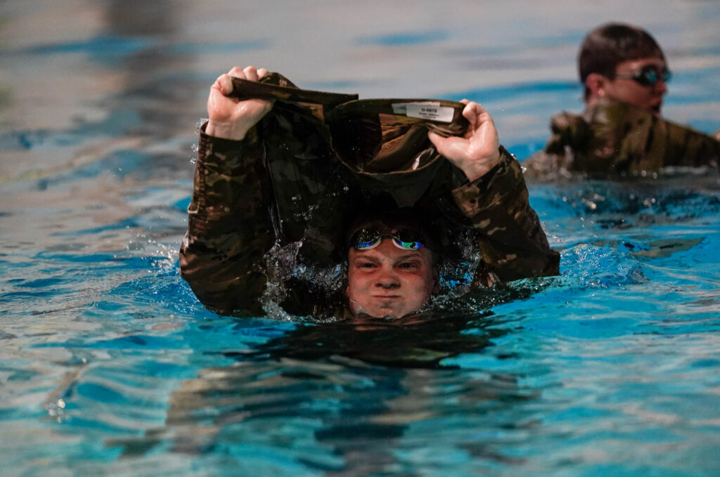 A cadet in OCPs in the swimming pool.