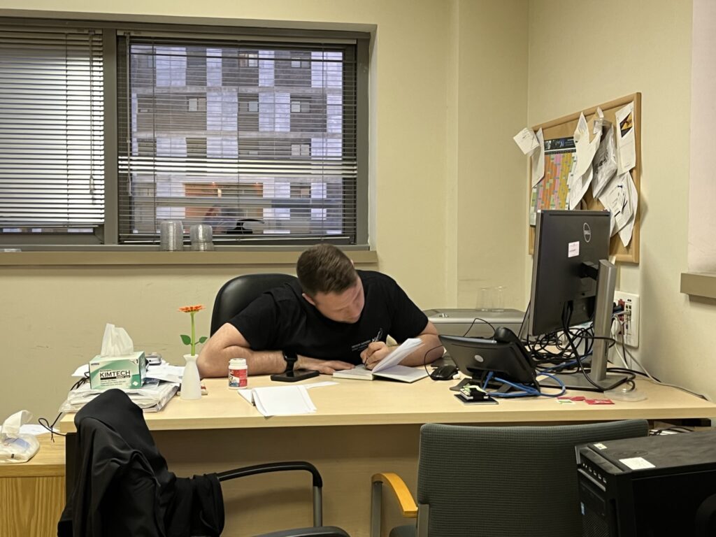 Chris Kushner ’24 doing research at a desk.