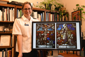 Lt. Col. Catharine Ingersoll poses with a photo of the two 16th century stained-glass panels which she confirmed the identity of the artist, patron, and original location for the Reading Public Museum.