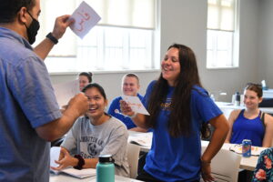 Maj. Hicham Assaoui, assistant professor in the Department of Modern Languages and Cultures, shares a light moment with students from last summer’s Arabic language program.