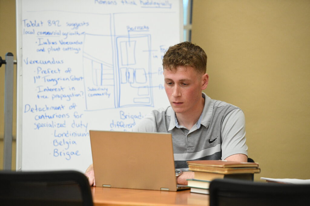 Jack Conley ’25, a history major is researching the hand-written letter, along with other ancient tablets, for his Summer Undergraduate Research Institute (SURI) project titled, “The Vindolanda Tablets: Understanding the Roman Frontier in Northern Britain.”