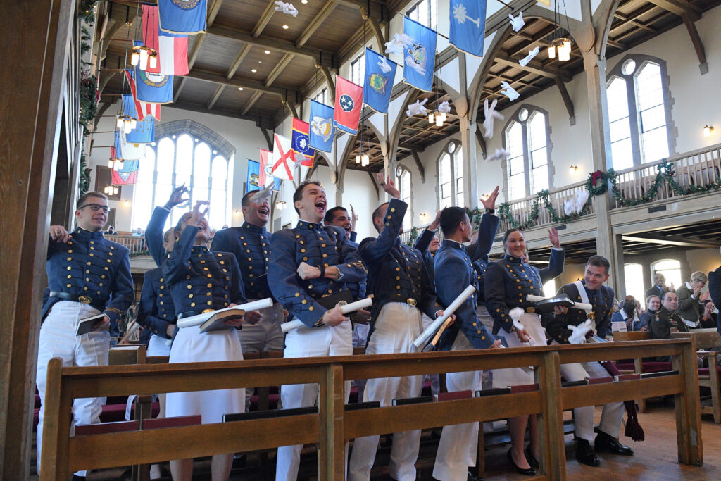 VMI graduates celebrate by tossing their gloves in the air after receiving their diplomas.