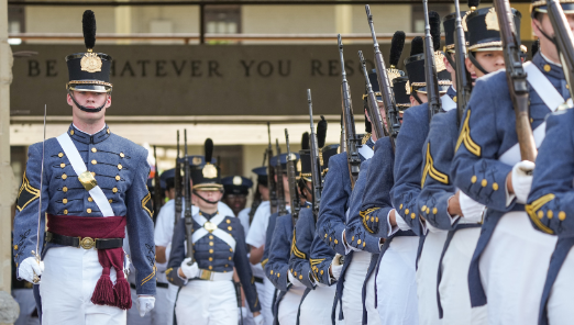 The VMI Corps of Cadets march out of barracks for a parade.