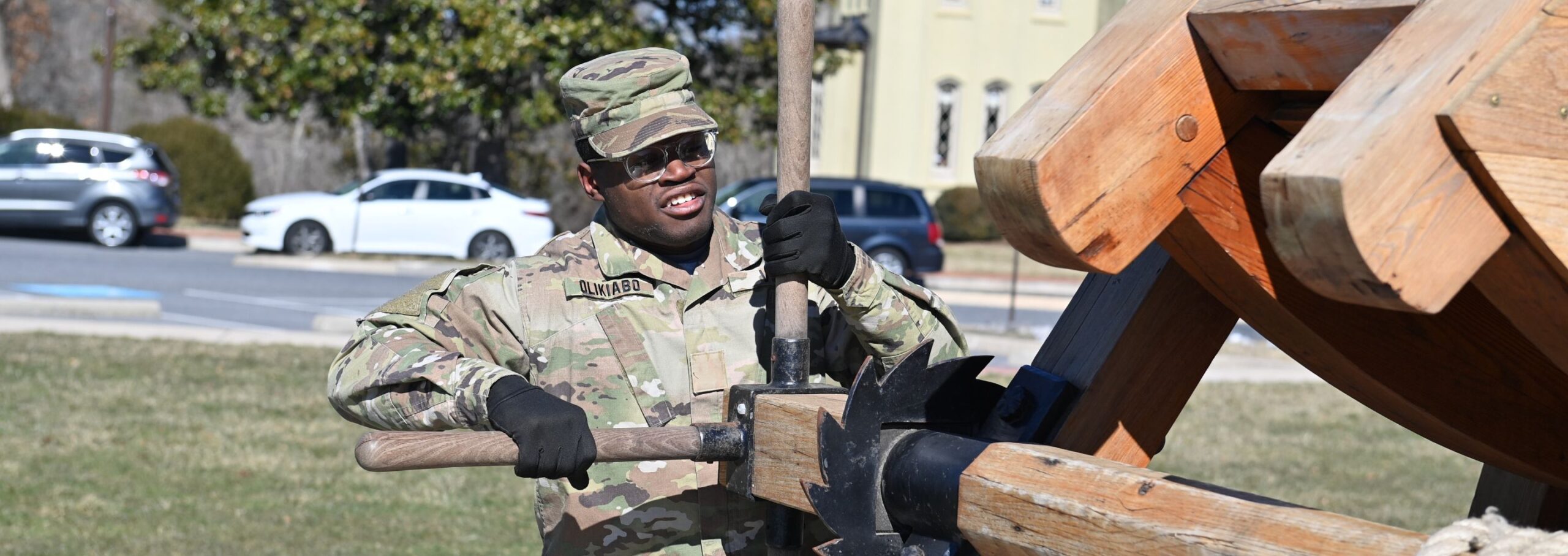 A cadet working a trebuchet.
