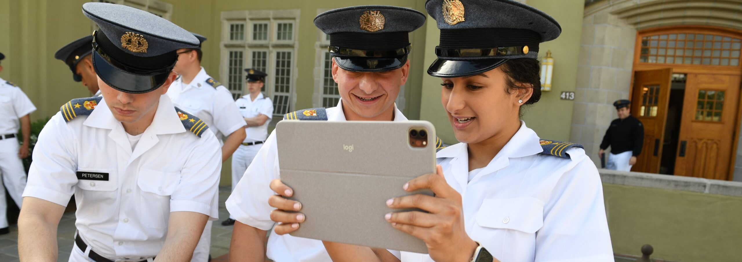 Cadets look at an iPad.