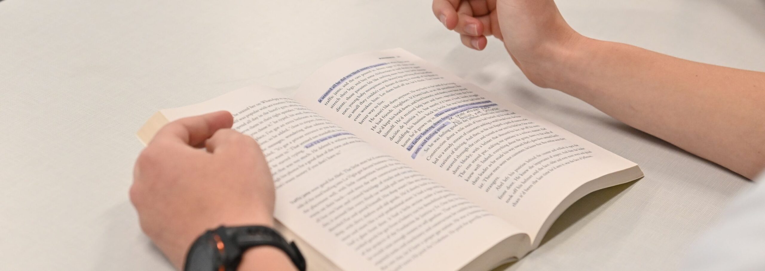 A cadet highlights in a book.