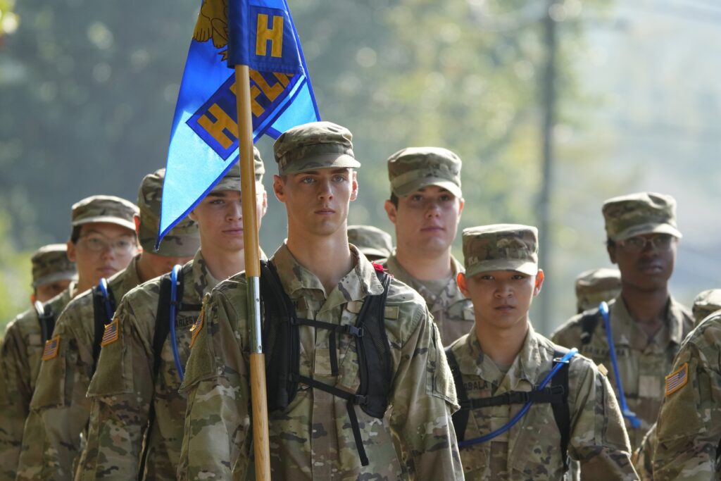 Air Force ROTC cadets in Det 880 march with their unit flag.