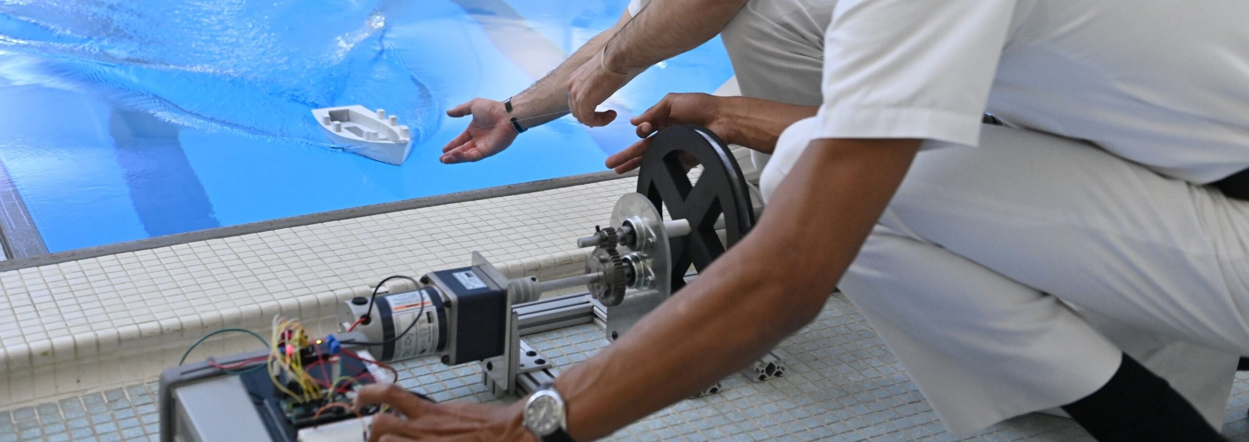 Cadets do a mechanical engineering experiment in the pool.