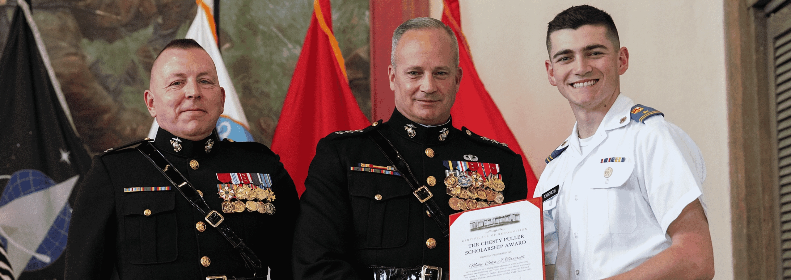NROTC Cadet poses with VMI and Naval ROTC commanders as he receives an award.