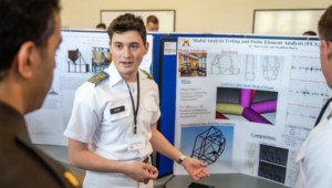 A cadet presents his research findings during the Undergraduate Research Symposium with a poster presentation.