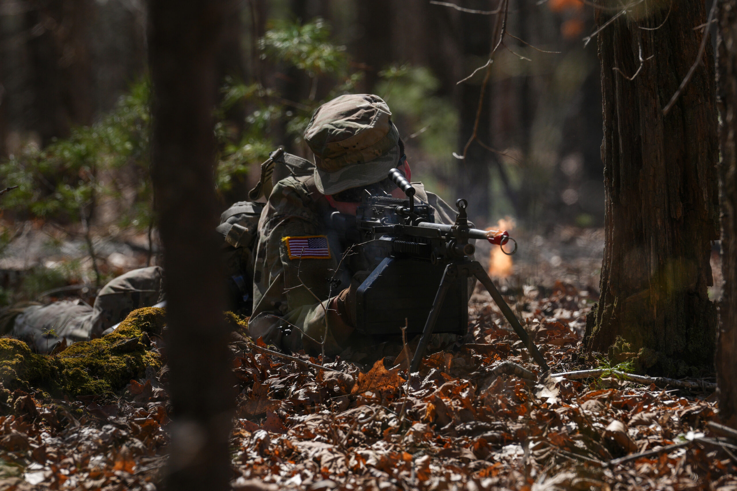 An Army ROTC cadet participates in training in the woods.